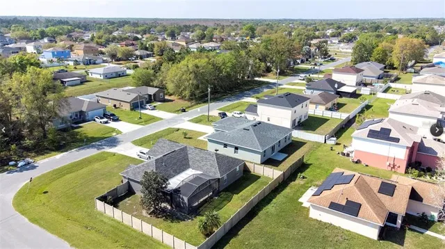 an aerial view of a house with a swimming pool garden and lake view