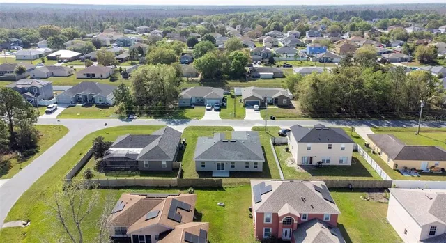 an aerial view of a swimming pool yard and outdoor seating
