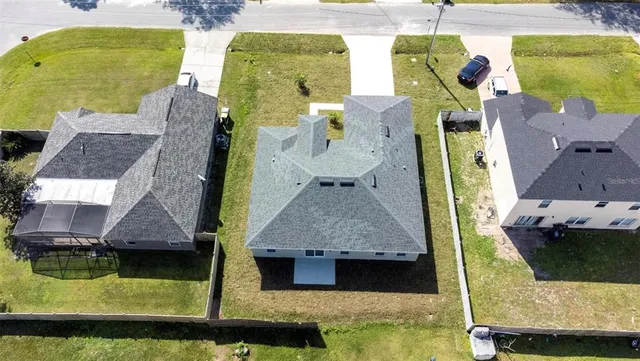 an aerial view of a house with a swimming pool