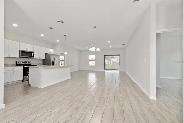 a view of kitchen with cabinets and wooden floor
