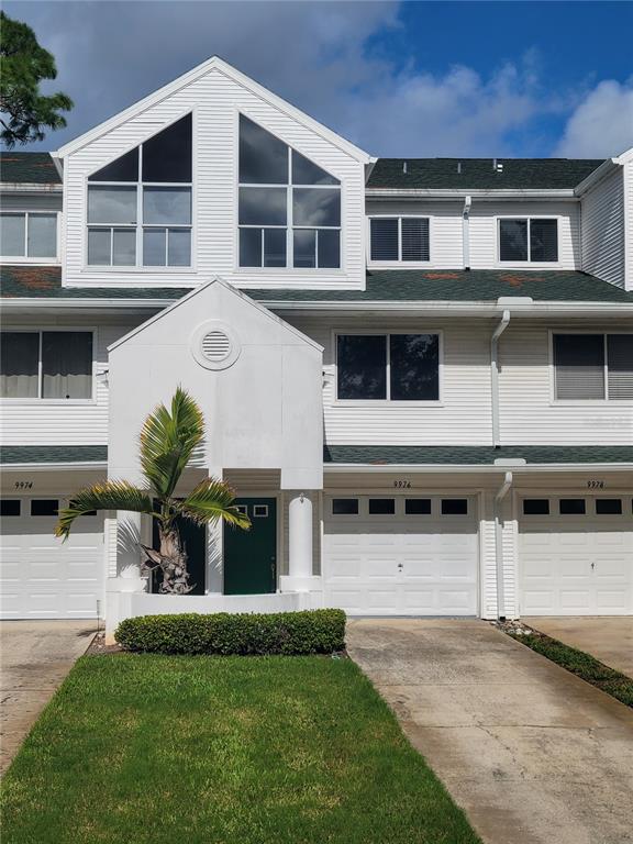 a front view of a house with a yard and garage