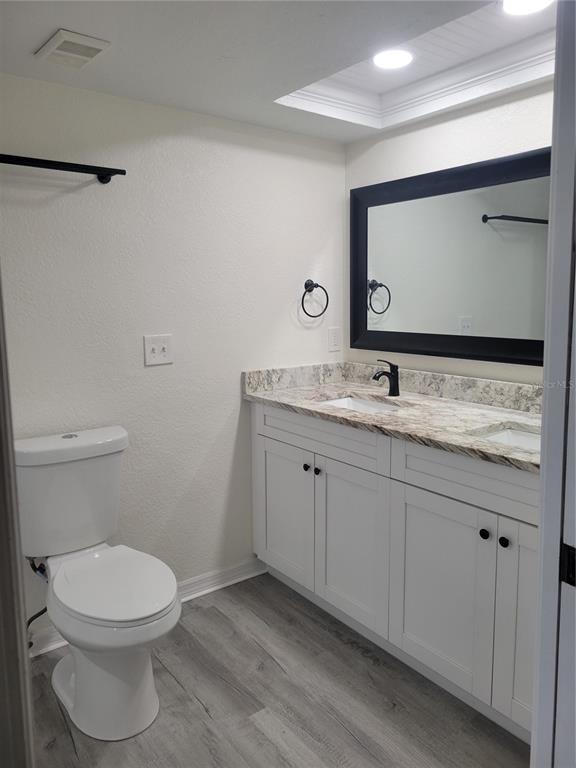 9976 Indian Key Trail, Unit 7 Seminole, FL 33776 - Photo 11 of 15 a bathroom with a toilet sink and mirror
