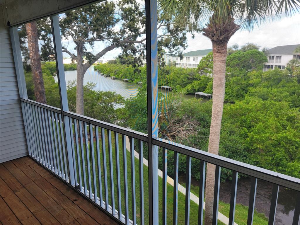 9976 Indian Key Trail, Unit 7 Seminole, FL 33776 - Photo 13 of 15 a view of a wooden street from a balcony