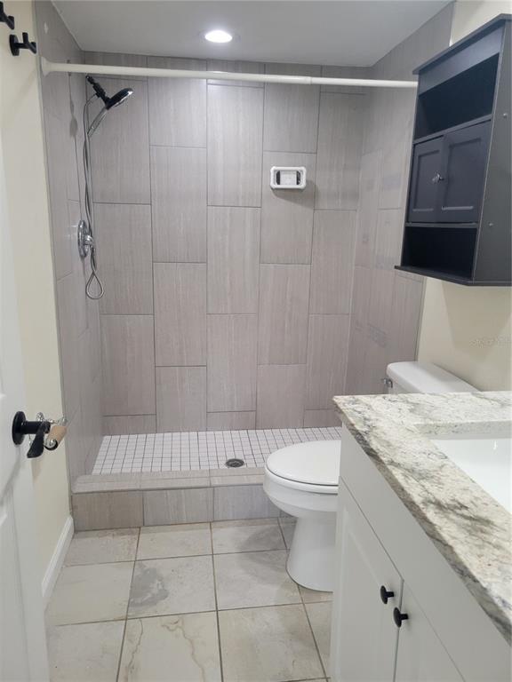 9976 Indian Key Trail, Unit 7 Seminole, FL 33776 - Photo 15 of 15 a bathroom with a granite countertop bathtub shower sink and toilet