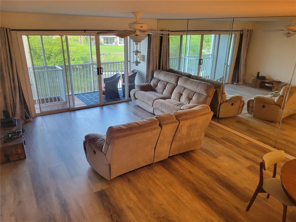 9976 Indian Key Trail, Unit 7 Seminole, FL 33776 - Photo 5 of 15 a living room with furniture and a large window