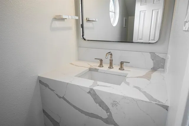 a bathroom with a sink and a mirror