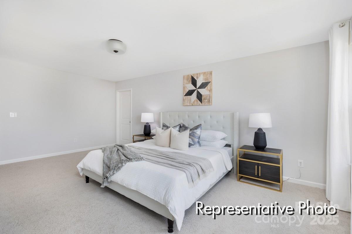 12540 Gotland Road, Unit 329 Midland, NC 28107 - Photo 14 of 22 a bedroom with a bed and a night stand