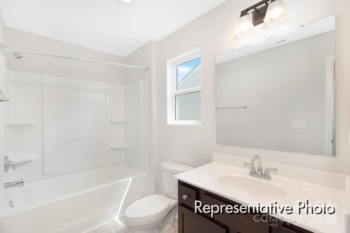 12540 Gotland Road, Unit 329 Midland, NC 28107 - Photo 20 of 22 a bathroom with a sink a toilet and a bathtub
