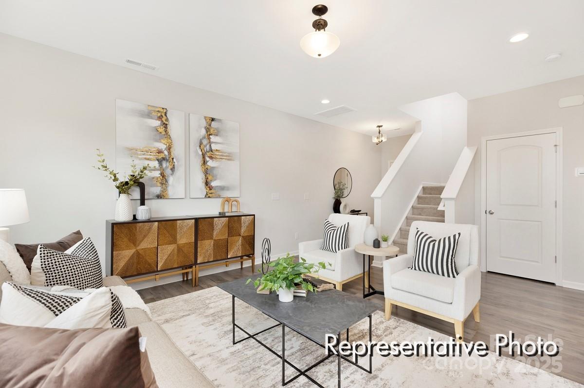 12540 Gotland Road, Unit 329 Midland, NC 28107 - Photo 8 of 22 a living room with furniture and wooden floor