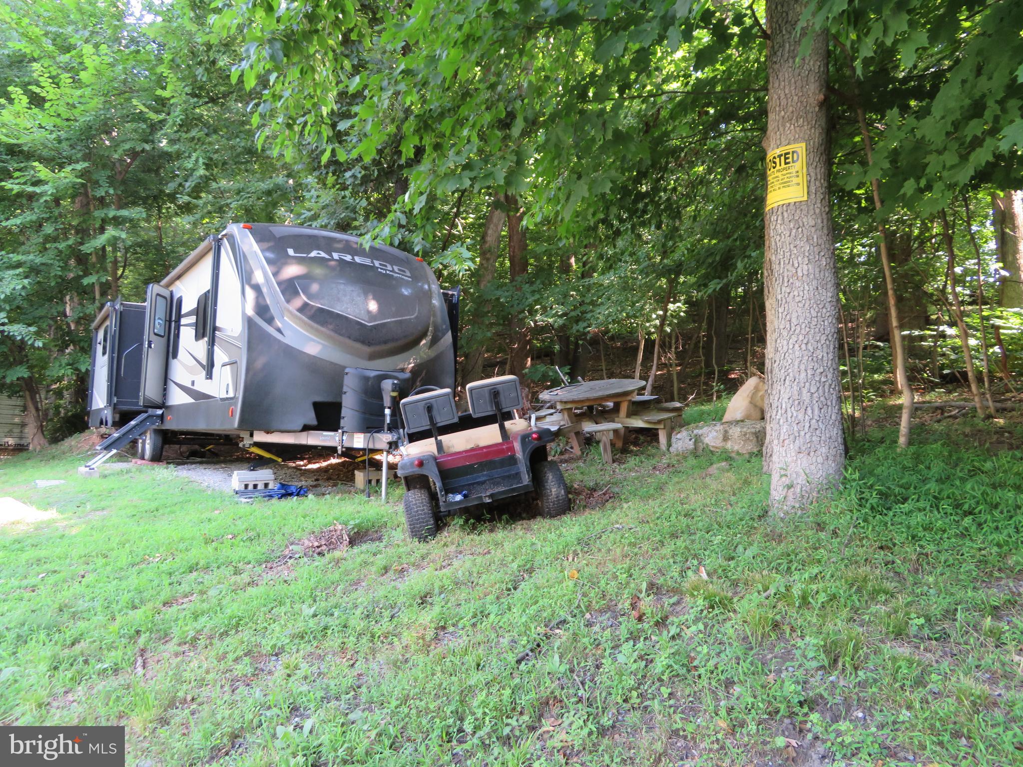 14 Detour Road Falling Waters, WV 25419 - Photo 11 of 31 a view of a backyard with table and chairs potted plants and large tree