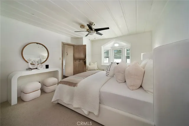 a bedroom with bed and a chandelier