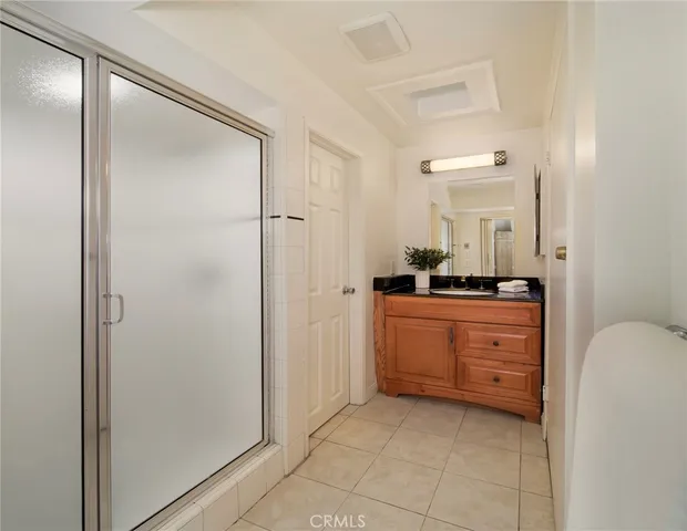 a bathroom with a shower a sink and a mirror