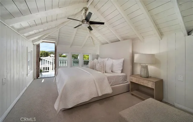 a bedroom with a bed and ceiling fan