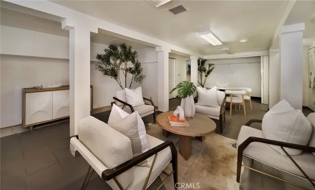 a living room with furniture and a potted plant