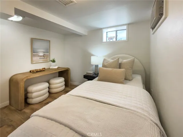 a bedroom with two beds and a couch