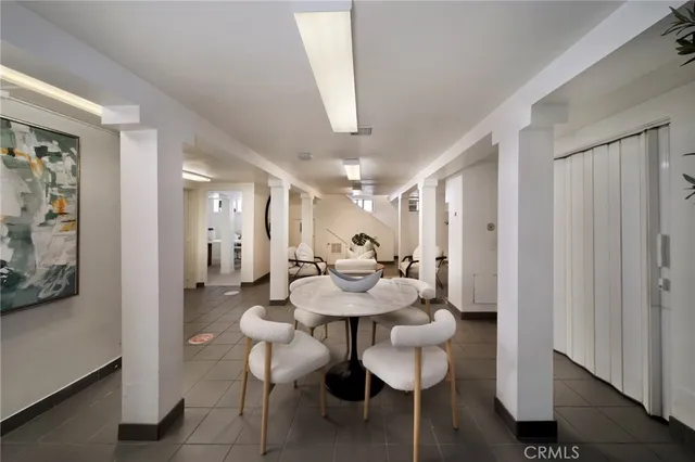 a view of a dining room with furniture and a chandelier fan