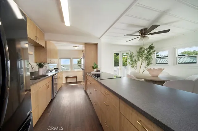 a large kitchen with stainless steel appliances lots of counter space and a sink