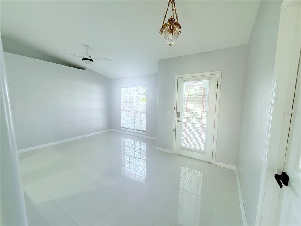 465 Haversham Road Deltona, FL 32725 - Photo 6 of 20 a view of empty room with windows
