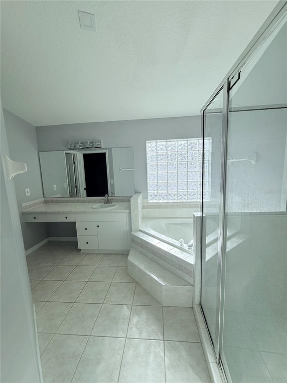 465 Haversham Road Deltona, FL 32725 - Photo 10 of 20 a bathroom with a tub toilet sink and mirror