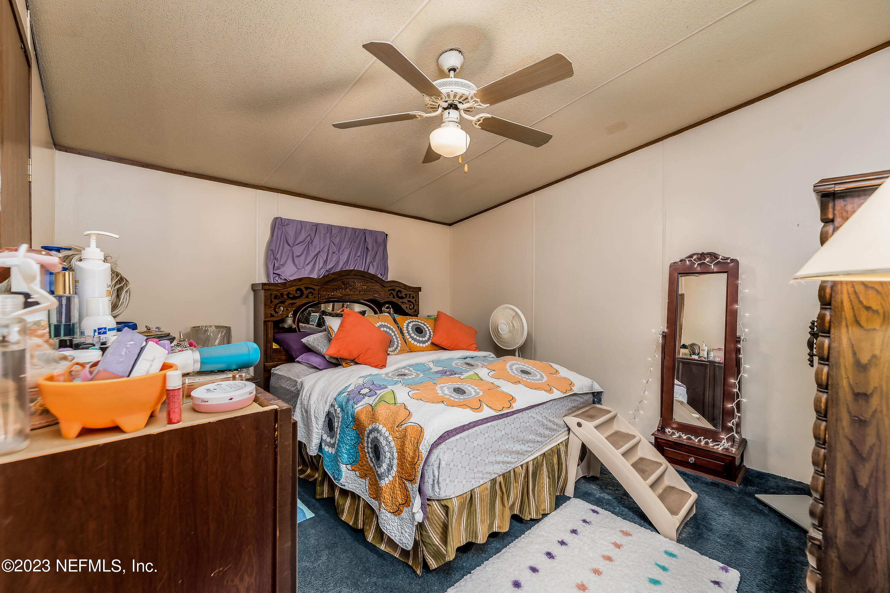 4014 Pinto Road Middleburg, FL 32068 - Photo 16 of 19 a bedroom with a bed and a chandelier