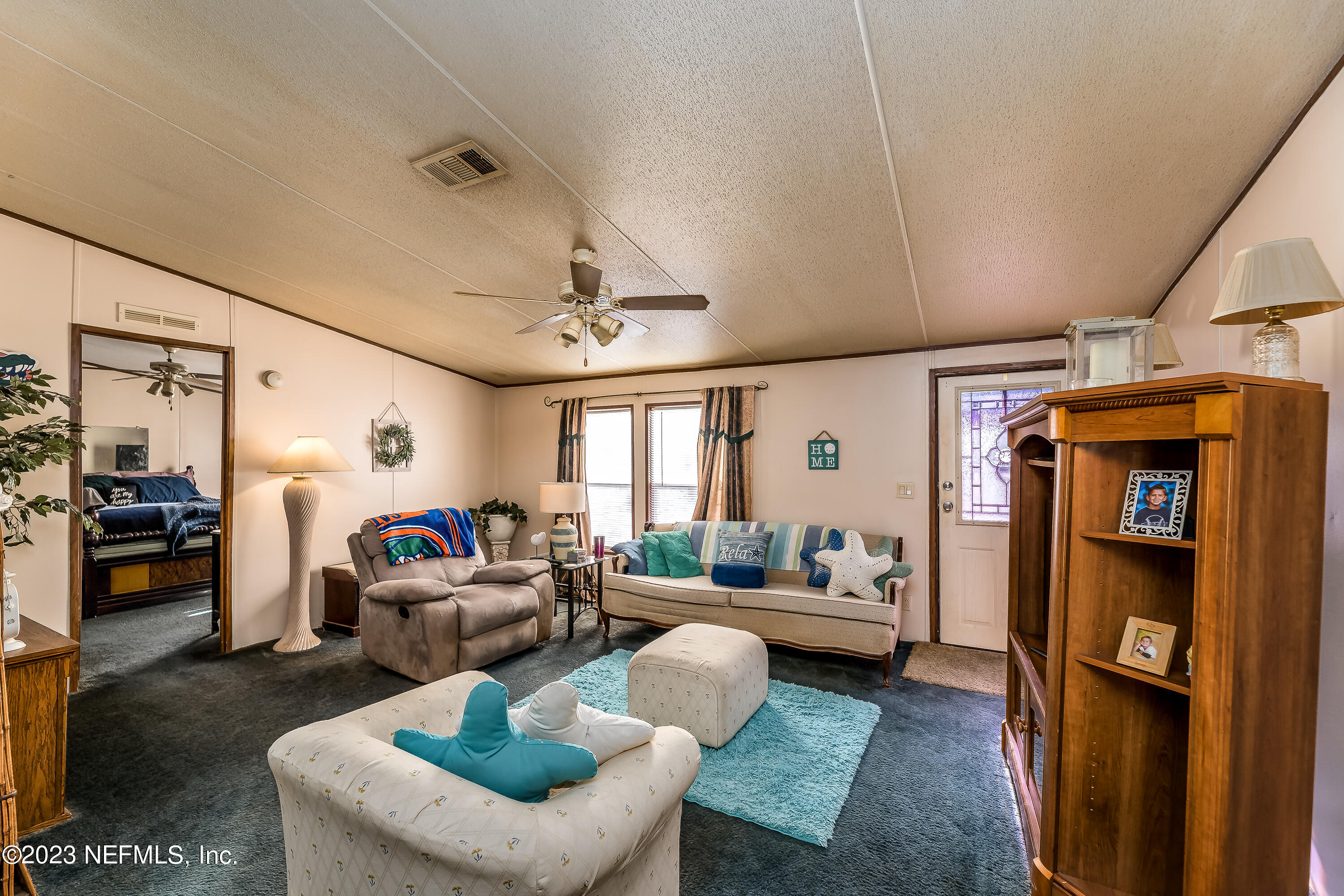 4014 Pinto Road Middleburg, FL 32068 - Photo 7 of 19 a living room with furniture ceiling fan and a rug