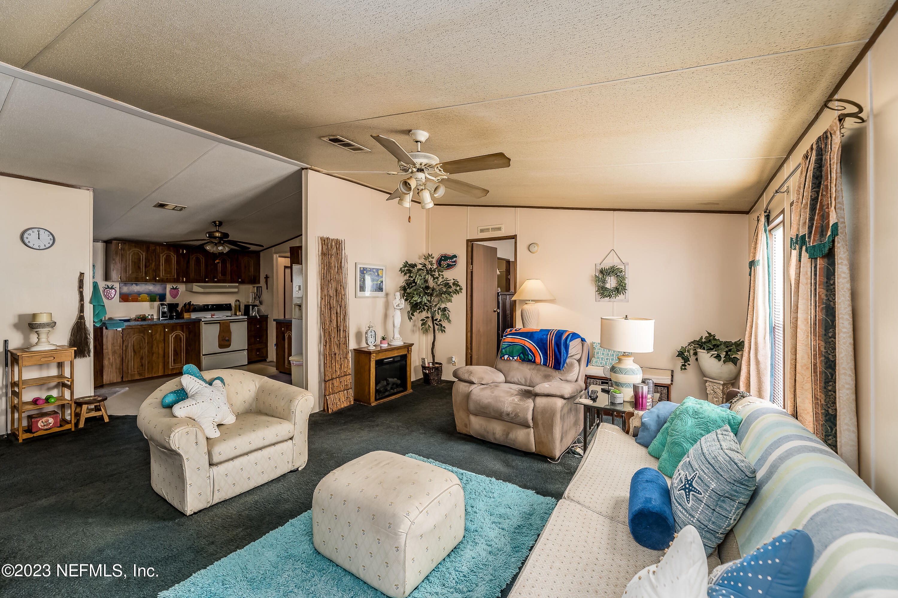 4014 Pinto Road Middleburg, FL 32068 - Photo 8 of 19 a living room with furniture and a chandelier