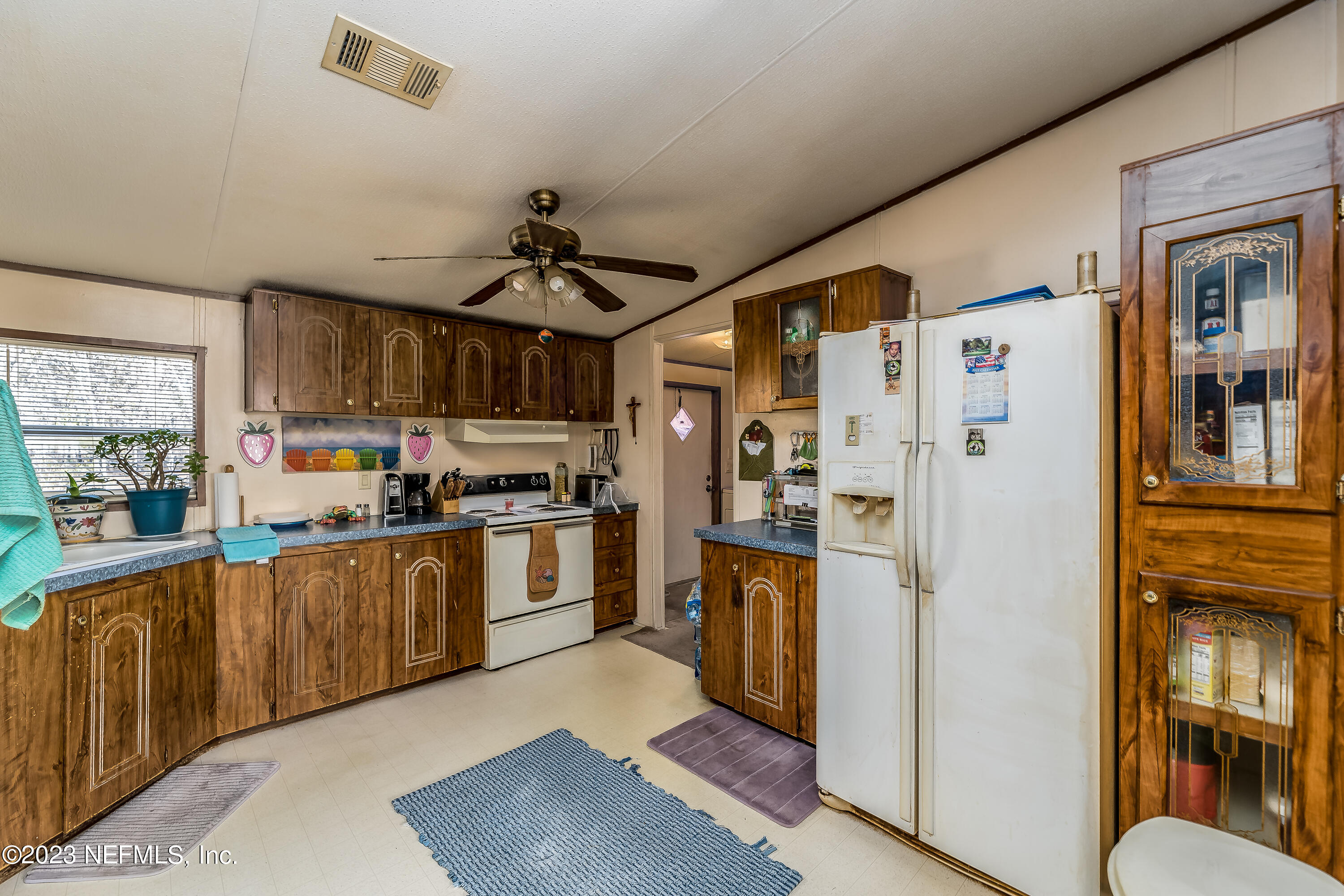 4014 Pinto Road Middleburg, FL 32068 - Photo 10 of 19 a kitchen with stainless steel appliances granite countertop a refrigerator a stove and a sink with cabinets