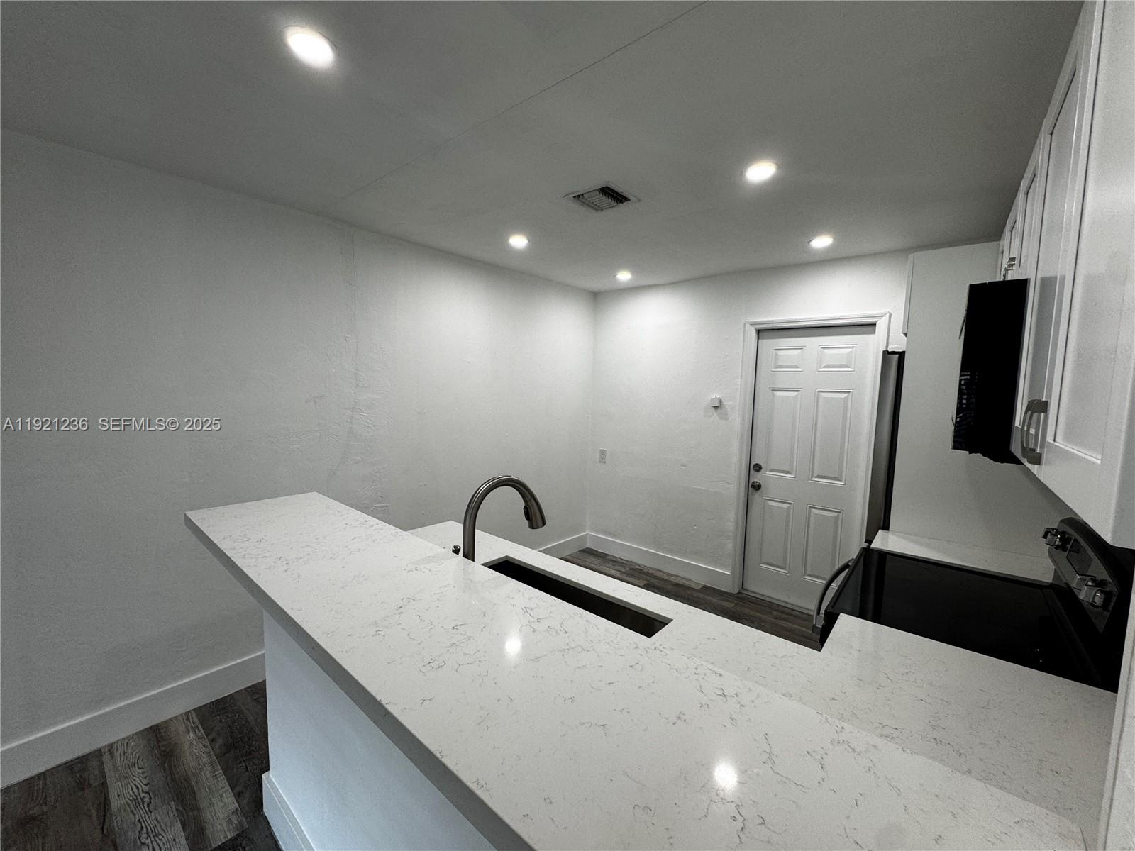 2034 Taylor Street Hollywood, FL 33020 - Photo 18 of 35 a bathroom with a sink a toilet and mirror