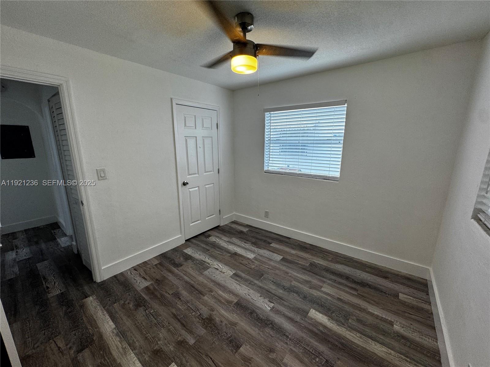 2034 Taylor Street Hollywood, FL 33020 - Photo 21 of 35 a view of an empty room with wooden floor and window