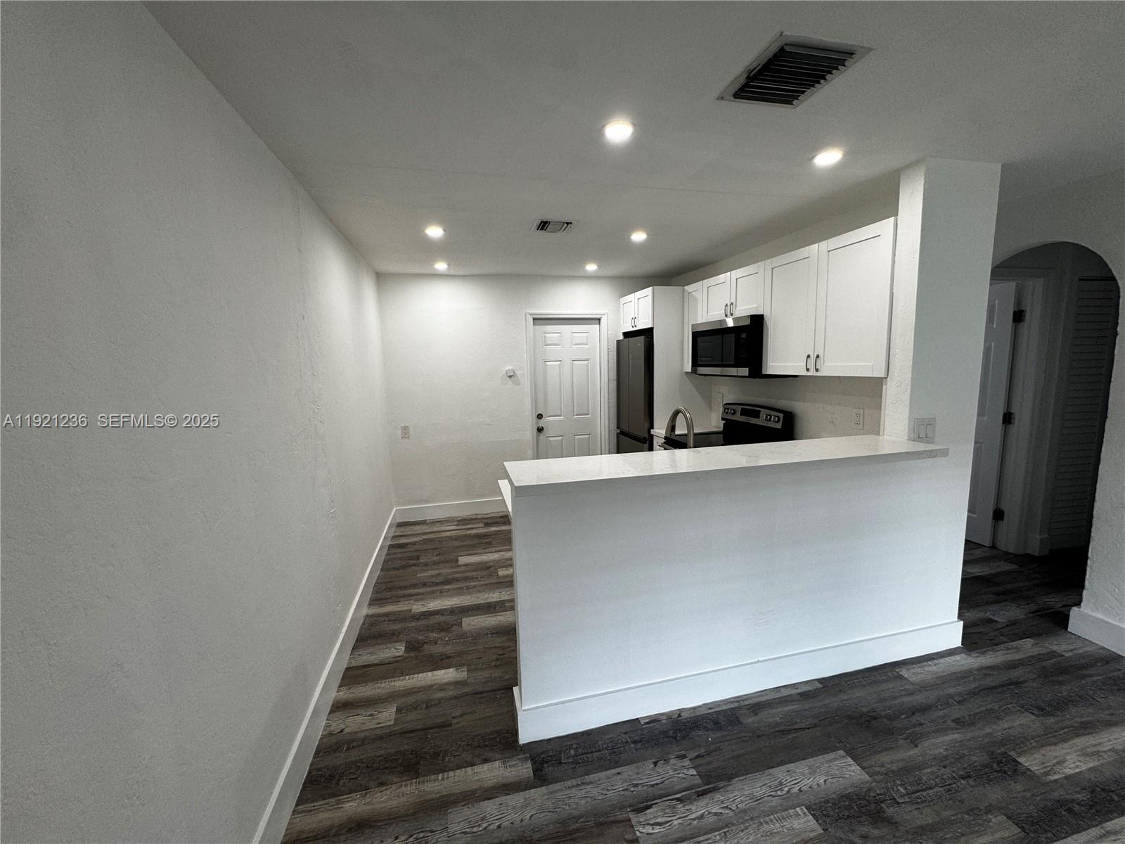 2034 Taylor Street Hollywood, FL 33020 - Photo 24 of 35 a view of kitchen with microwave a stove and a refrigerator