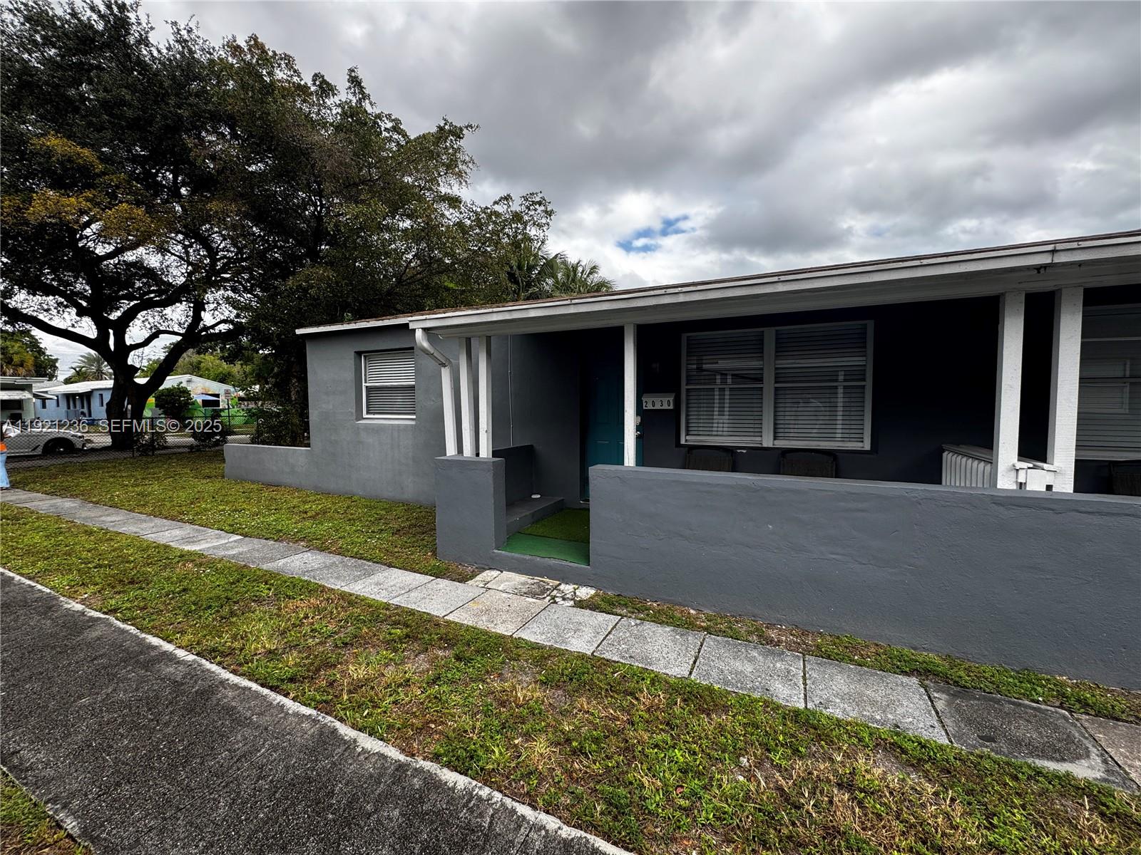 2034 Taylor Street Hollywood, FL 33020 - Photo 4 of 35 a front view of a house with a yard