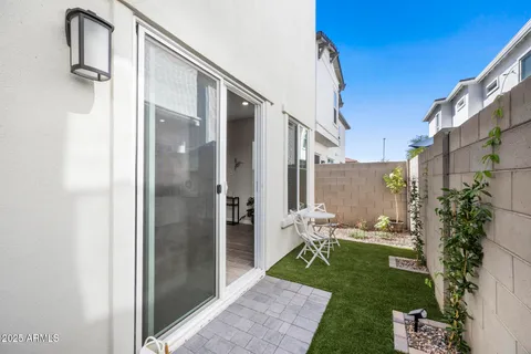 a view of a porch with couches and potted plants