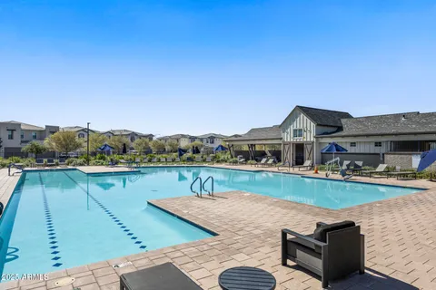 a view of a patio with a table and chairs under an umbrella