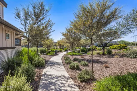 a front view of a house with a yard and potted plants