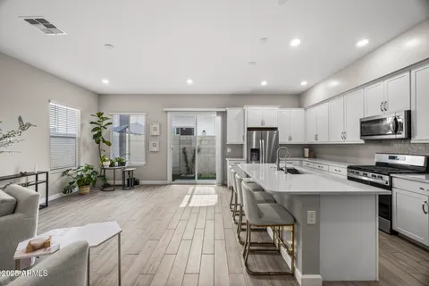 a kitchen with stainless steel appliances a sink a stove and microwave
