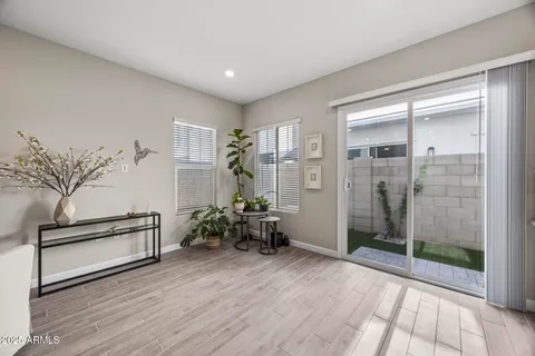 a large kitchen with sink a refrigerator and chairs