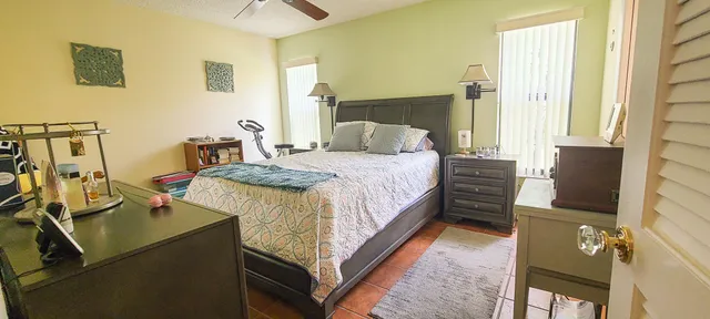 a en suite bathroom with a granite countertop sink and a mirror
