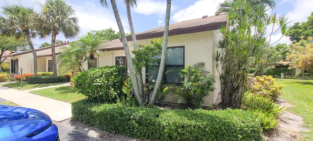 a kitchen with a refrigerator a stove a sink dishwasher and wooden cabinets with wooden floor