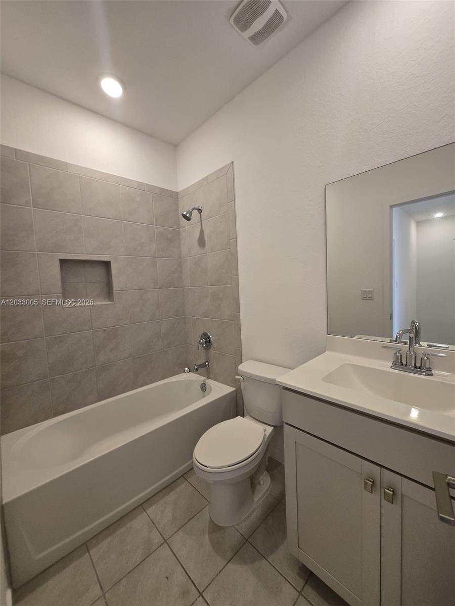 862 Southeast 17 Street, Unit 862 Homestead, FL 33034 - Photo 25 of 39 a bathroom with a sink a toilet a mirror and shower