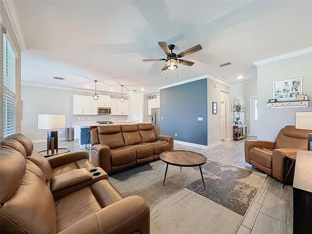 a kitchen with stainless steel appliances a stove a sink island and a refrigerator