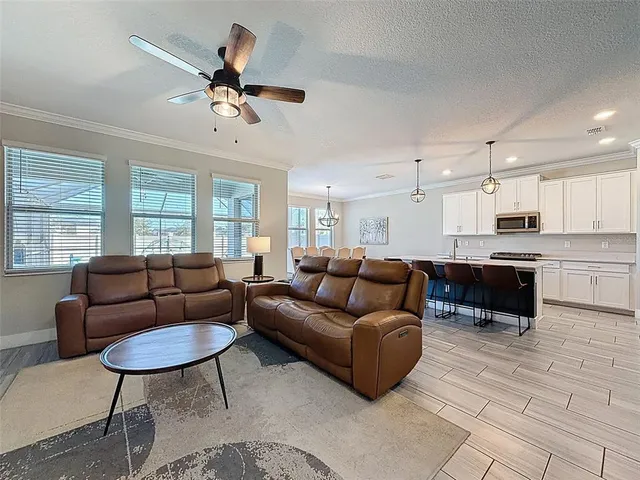 a kitchen with a sink stainless steel appliances and white cabinets