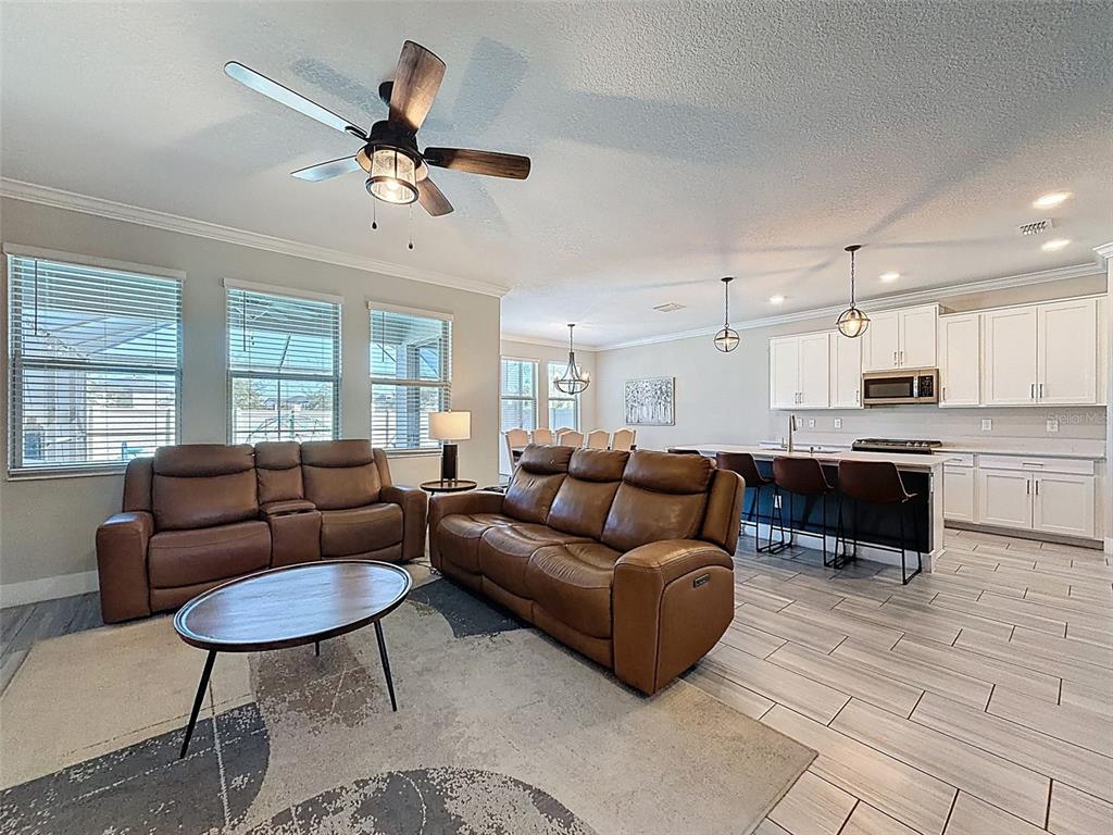 8124 Olympic Stone Circle Trinity, FL 34655 - Photo 13 of 75 a living room with furniture kitchen view and a window