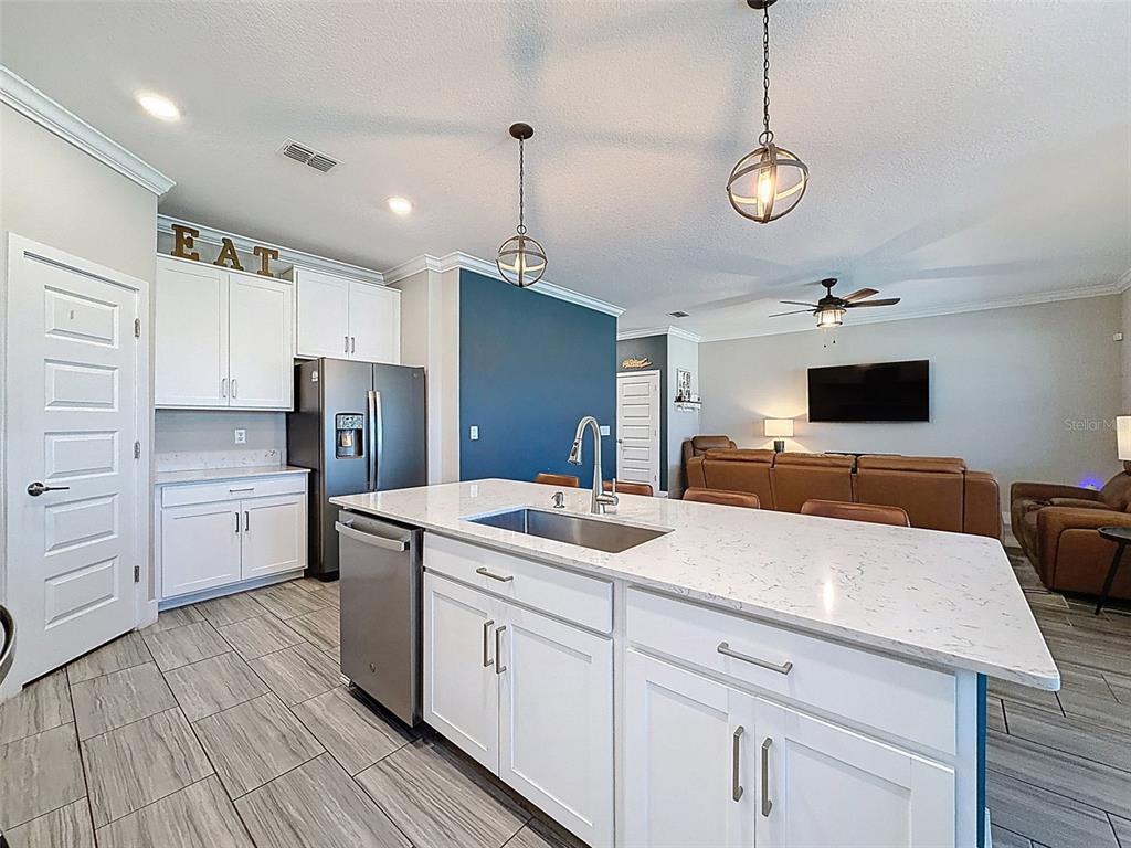 8124 Olympic Stone Circle Trinity, FL 34655 - Photo 17 of 75 a kitchen with a sink stainless steel appliances and white cabinets