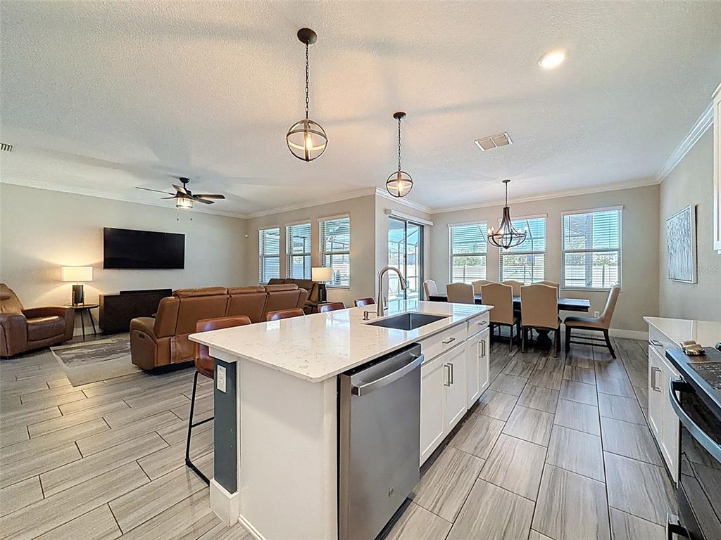 8124 Olympic Stone Circle Trinity, FL 34655 - Photo 23 of 75 a large kitchen with a table and chairs