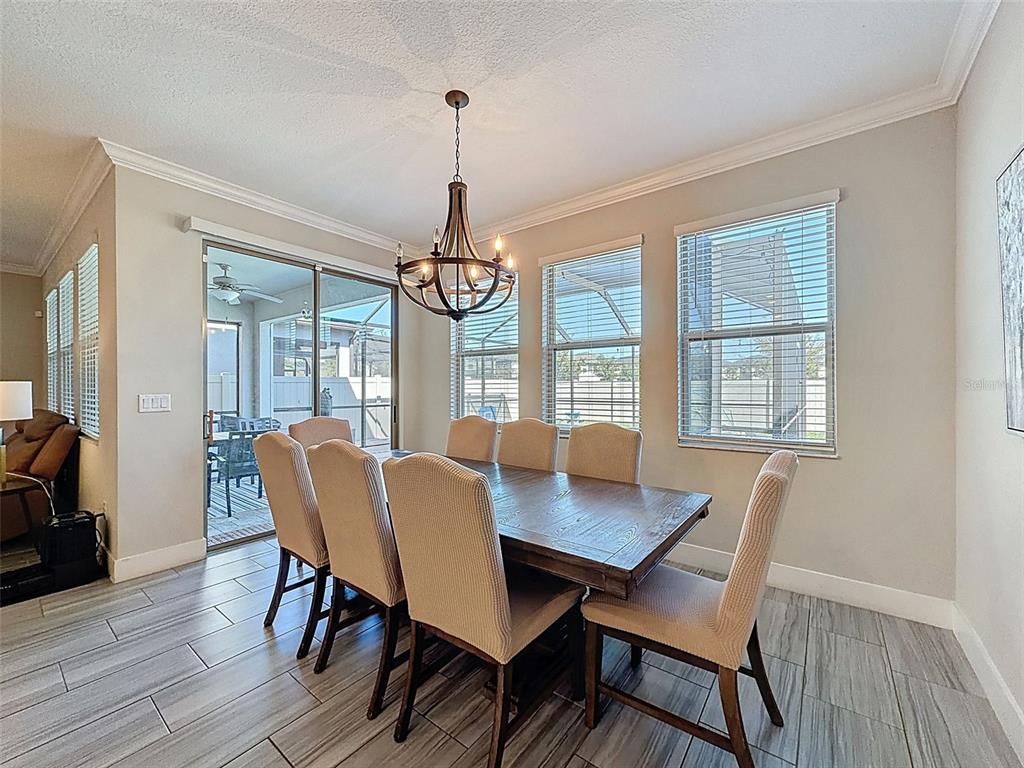 8124 Olympic Stone Circle Trinity, FL 34655 - Photo 25 of 75 a view of a dining room with furniture window and wooden floor