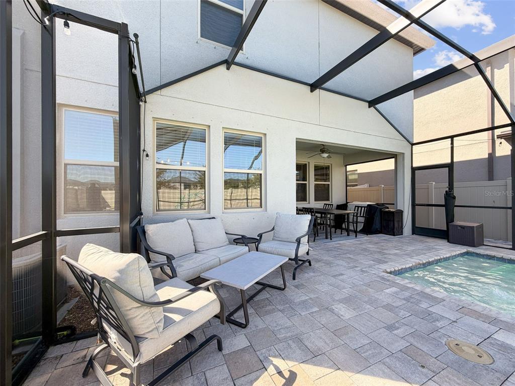 8124 Olympic Stone Circle Trinity, FL 34655 - Photo 28 of 75 a outdoor space with patio the couches and a dining table with the view of the house