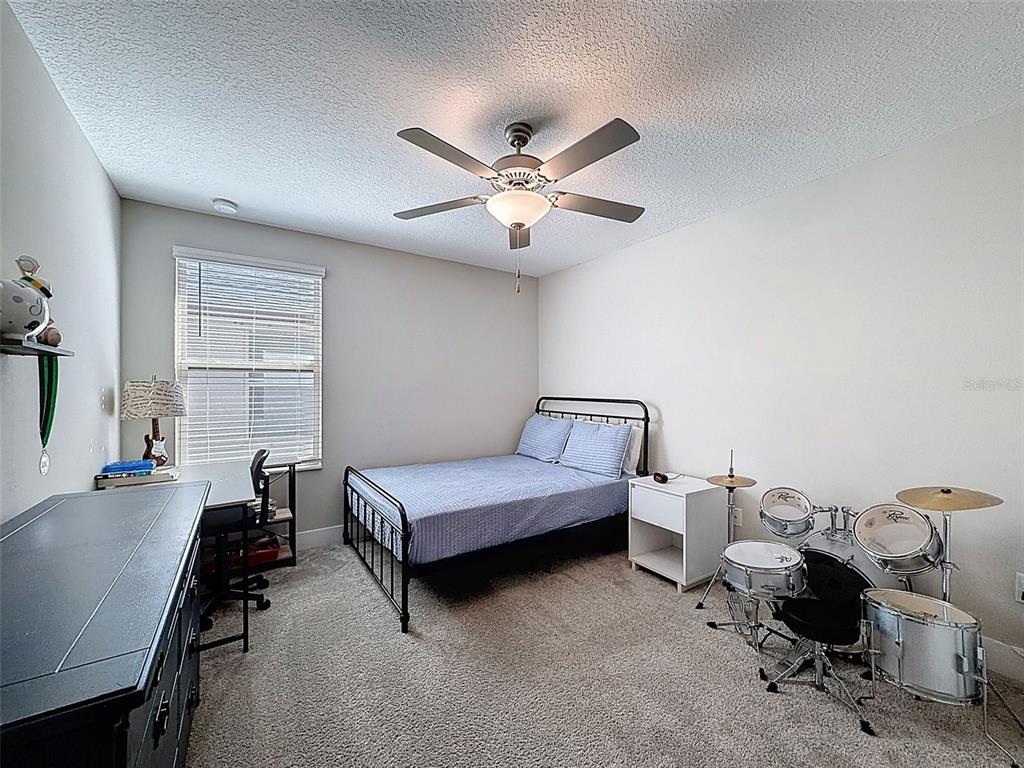 8124 Olympic Stone Circle Trinity, FL 34655 - Photo 42 of 75 a bedroom with furniture and a window