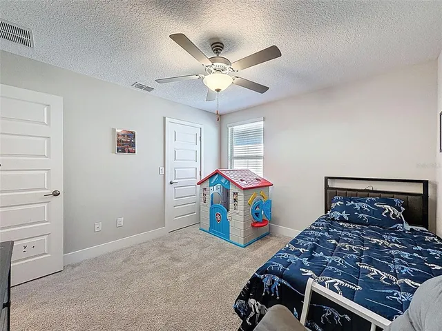 a view of a fountain in front of a house with a yard