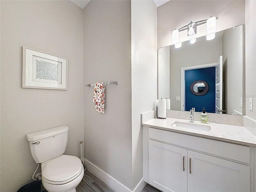 8124 Olympic Stone Circle Trinity, FL 34655 - Photo 48 of 75 a bathroom with a toilet sink vanity and mirror