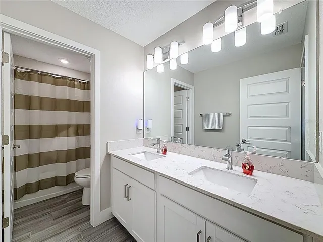 an aerial view of a house with garden space and sitting area